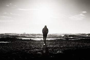 man standing near ocean grayscale photography