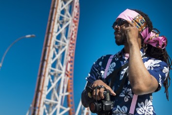 Man Standing Near Park Roller Coaster
