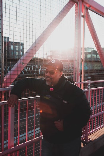 Man Standing Near Pink Stainless Steel Railings Smiling