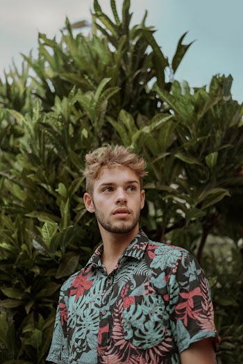 Man Standing Near Plant
