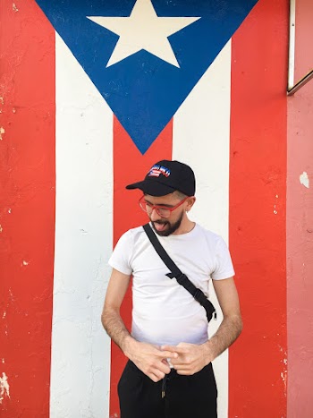 Man Standing Near Puerto Rico Flag