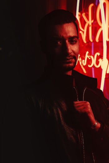 Man Standing Near Red Lights