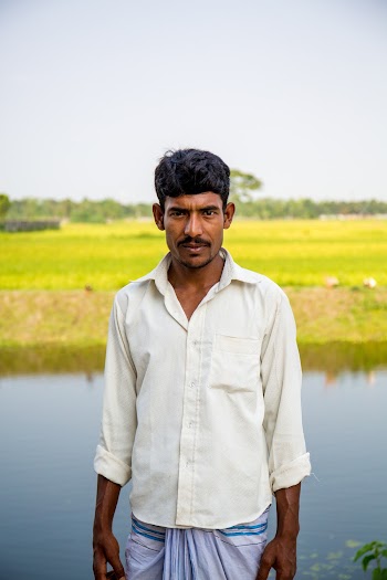 Man Standing Near Rice Field