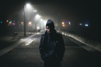 man standing near street lights