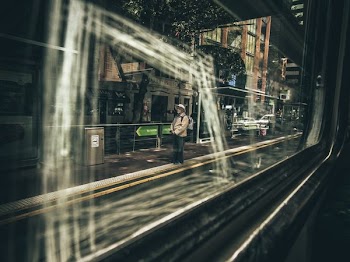 man standing near vehicle road