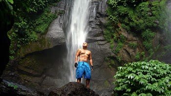 Man Standing Near Waterfalls