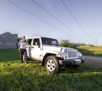 Man Standing Near White Jeep Wrangler Suv