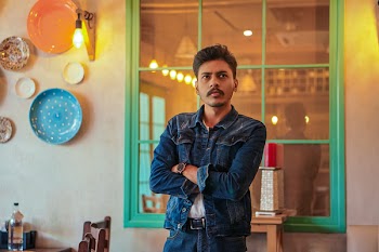 Man Standing Near Window