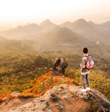Man Standing on a Mountain Summit