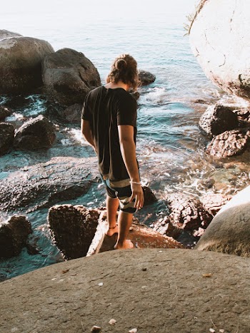 Man Standing On A Rock