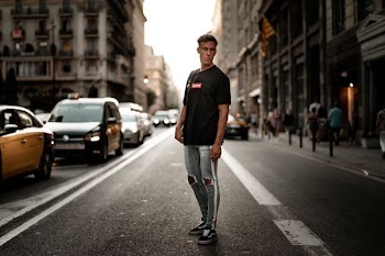 man standing on asphalt road