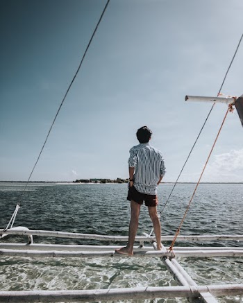 Man Standing on Boat