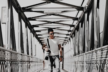 Man Standing On Bridge