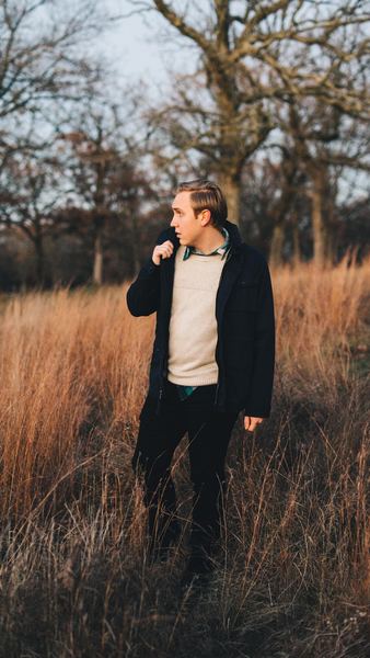 man standing on brown field