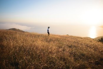 man standing on brown field during daytime