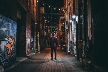 Man Standing on Brown Pathway