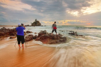 Man Standing on Brown Rock Formation
