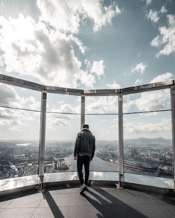Man Standing on Building Top