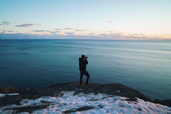 Man Standing On Cliff