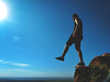 Man Standing on Cliff