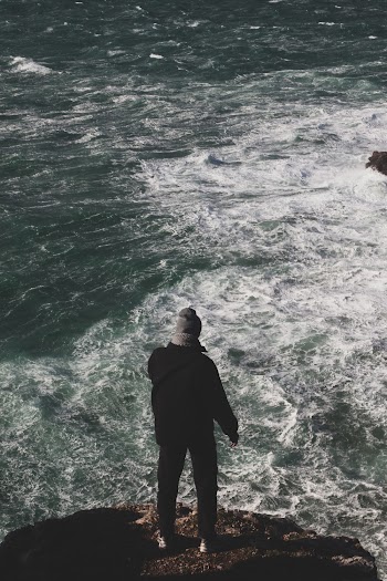 Man Standing on Cliff