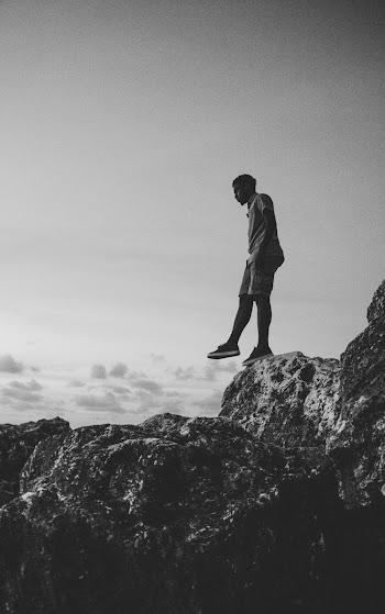 Man Standing on Cliff