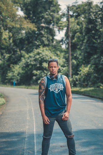 Man Standing on Concrete Road Near Trees