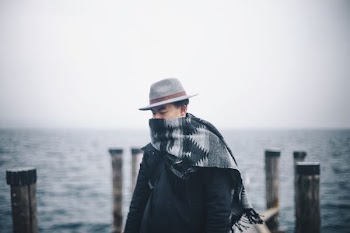 man standing on dock during day time