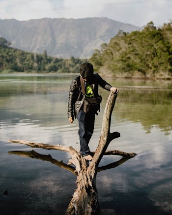 Man Standing on Driftwood