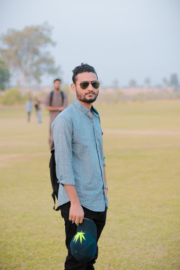 Man Standing on Field While Holding Cap
