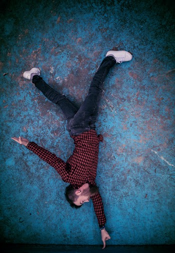 Man Standing on Finger Photo