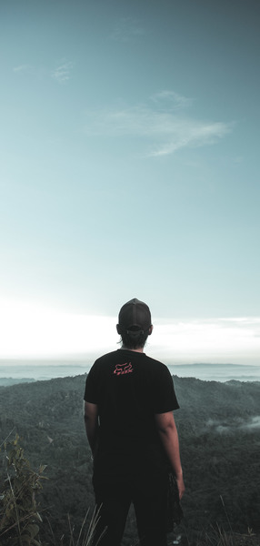 Man Standing on Front of Mountain