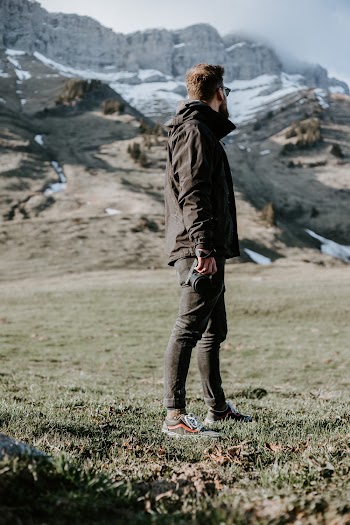 Man Standing On Grass Field