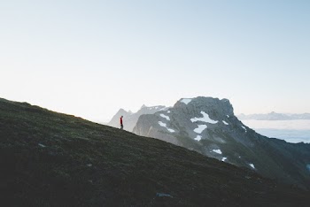 Man Standing on Green Hill