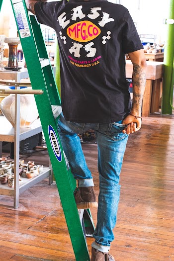 Man Standing on Green Werner Ladder