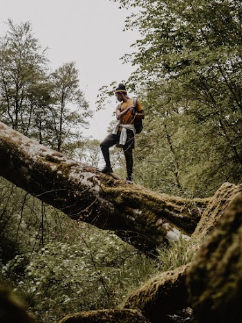 Man Standing On Log