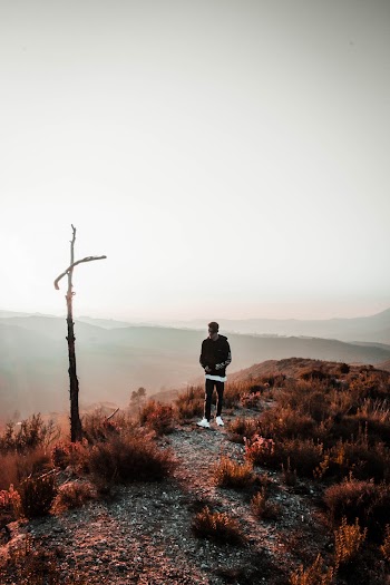 Man Standing on Mountain Ridge