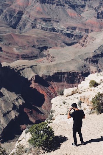 man standing on mountain rocks