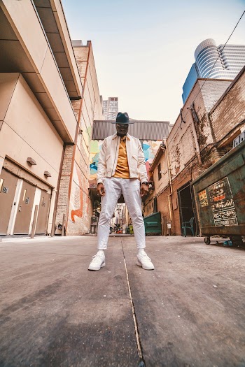 Man Standing on Pavement