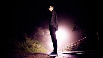 man standing on road