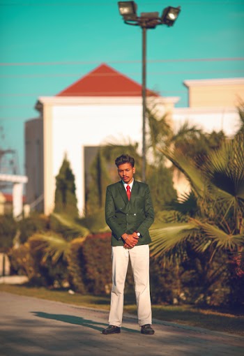 Man Standing on Road Near Bushes