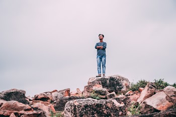 Man Standing On Rock