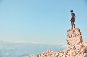 man standing on rock