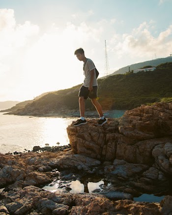 Man Standing on Rock Formation
