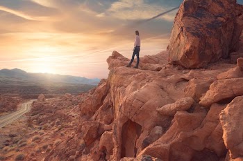 man standing on rock formations