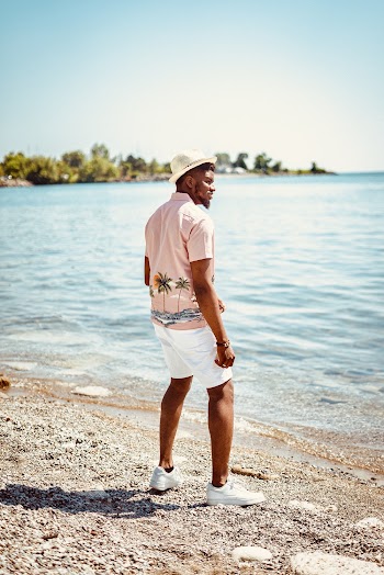 Man Standing on Shore Facing the Sea during Day