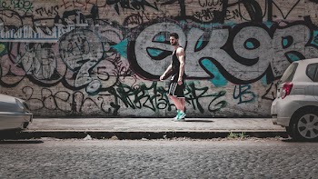 Man Standing On Sidewalk
