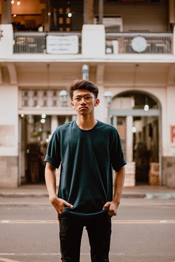Man Standing on Sidewalk