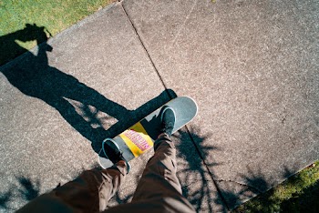 Man Standing on Skateboard
