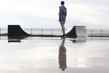 man standing on skateboard near ramp